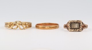 A 19th Century 9ct yellow gold in memoriam ring, size K, 1.5 grams, a 14ct yellow gold knot ring, size R, 2.5 grams and a 14ct yellow gold wedding band size M, 1.3 grams 