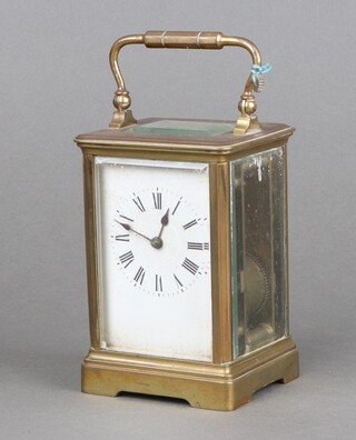 A 19th Century French 8 day striking carriage clock, the 6cm dial with Roman numerals, striking on a gong, contained in a gilt metal case 12cm h x 8cm w x 7cm d, complete with key and spare cog 