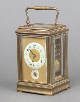 A 19th Century French 8 day carriage alarm clock with circular circular porcelain dial with Arabic numerals, contained in a gilt metal gorge case, the top marked WS to Claude Shoolbred November 1st 1890 15cm h x 9cm w x 8cm d, complete with key 