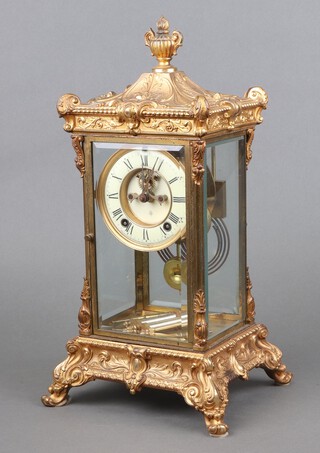 Ansonia Clock Company, an American 8 day striking 4 glass clock with 10cm enamelled dial, Roman numerals and visible escapement, striking on a gong, contained in a gilt 4 glass case 42cm h x 22cm w x 19cm d, complete with 2 pendulums and 2 keys 