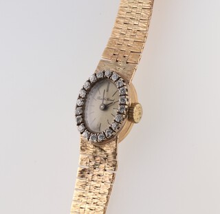 A lady's 9ct yellow gold Bueche Girod diamond set oval wristwatch, surrounded by brilliant cut diamonds 9.4ct, 20.5 grams gross 