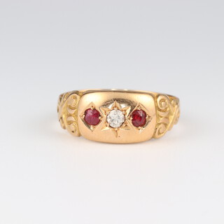 An 18ct yellow gold ruby and diamond ring, the rubies 0.10ct, the diamond 0.05ct, size O 1/2, 3.2 grams 