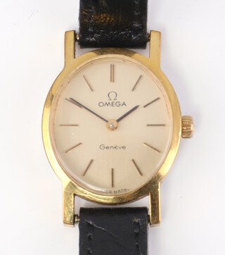 A lady's gilt cased oval Omega mechanical wristwatch on a leather bracelet in a 20mm case, complete with box 