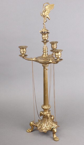 An Empire style brass 3 light candelabrum with ram masks, raised on claw feet 51cm, now with exotic bird removable finial 