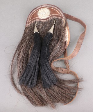 A leather sporran with London Scottish cap badge