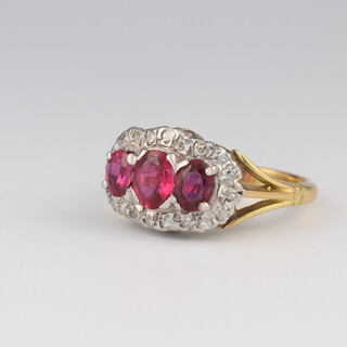 An 18ct yellow gold ruby and diamond triple cluster ring, the rubies approx. 1ct, the diamonds 0.25ct, size K, 5.1 grams 