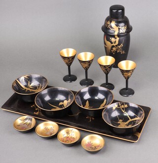 A 1930's Japanese black and gilt lacquered cocktail set including cocktail shaker decorated a cockerel, 3 bowls decorated bamboo and storks,  4 small bowls with gilt interiors decorated flowers, drinking cups, tray etc 