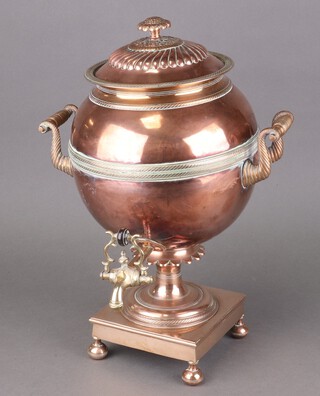 A Regency copper and brass tea urn with embossed lid, raised on a square base with bun feet 40cm h x 32cm diam. 