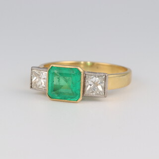 An 18ct yellow gold princess cut emerald and diamond ring, the emerald 1.5ct, the diamonds each 0.50ct, size Q, 4.4 grams 