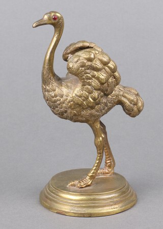 A Victorian gilt bronze pen holder in the form of a standing ostrich with hardstone eyes, raised on a circular base 15cm h x 8cm 