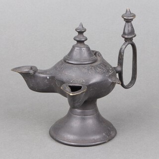 A Persian bronze twin light oil lamp of baluster form, raised on a spreading foot 12cm h x 12cm w x 15cm d 