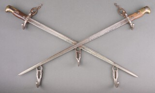 A Trench Art coat rack formed from 2 French chassepot bayonets in saltire 65cm 
