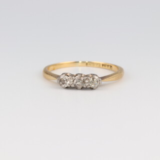 An 18ct yellow gold 3 stone diamond ring, 0.03ct, size J 1/2, 1.7 grams 
