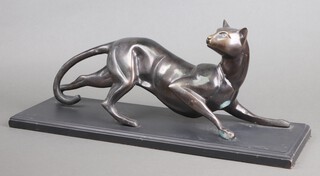 An Art Deco style figure of a crouching bronze cat, raised on a wooden base 25cm h x 60cm w x 20cm d 