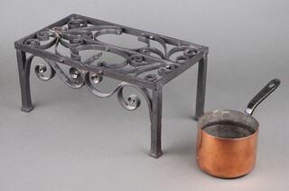 A 19th Century copper saucepan with iron handle 10cm x 13cm together with a heavy gauge rectangular wrought iron footman 18cm x 39cm x 21cm (1 prong missing)