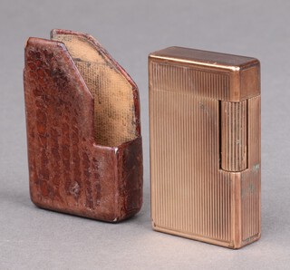 A gentleman's gilt engine turned Dupont cigarette lighter in a leather pochette, lacking base screw 