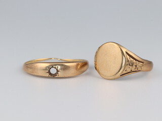 Two 9ct yellow gold rings, size G and N 1/2, 4.5 grams 