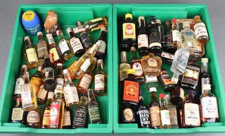A collection of bourbon, rum and other miniatures including Canadian Club, Jack Daniels, Beam's Choice, Wild Turkey, Lamb's Navy Rum, etc 
