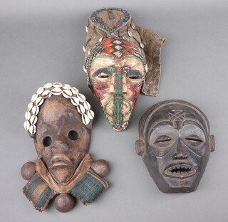 A carved African mask 22cm x 18cm and 2 others 
