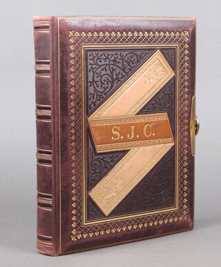 A Victorian leather bound photograph album with gilt page endings, containing 110 Victorian and later portrait photographs 