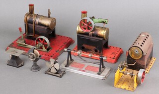 Two Mamod stationary steam engine (moving parts are free and running) and a Meccano stationary steam engine, a Wilesco metal machinery running belt, an unmarked steam driven circular saw on a black plastic base 5cm x 6cm x 4cm, a similar grindstone 8cm x 4cm x 2cm on a metal stand and a fan 6cm x 5cm x 3cm 