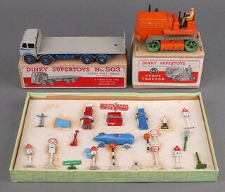 A Dinky Super Toys 563 Blaw Knox bulldozer in orange, boxed, ditto 503 Foden flat bed truck grey cab, dark blue body, flash and spare tyre and a Crescent Toys garage/racing road set comprising petrol pumps, racing car and road signs 