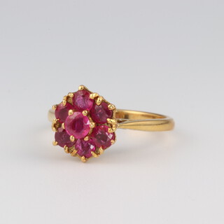 An 18ct yellow gold 7 stone ruby ring, approx 0.7ct, size L, 3.9 grams 