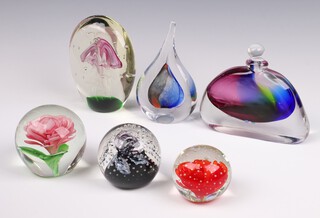 A tear drop shaped glass paperweight, the base inscribed LH 14cm, a spiral bubble glass paperweight marked ONG and 3 other unmarked paperweights together with a 2 colour glass arch shaped scent bottle 12cm (stopper a/f)