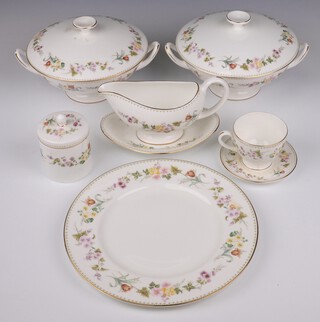 A 113 piece Wedgwood Mirabelle pattern dinner service comprising 2 tureens and covers, oval meat plate, 2 oval bowls, sauce boat and stand, 12 dinner plates, 9 side plates, 12 soup bowls, 12 tea plates (3 cracked, 1 chipped), 12 pudding bowls, 12 tea cups, 12 saucers (1 cracked), 13 coffee cans (1 chipped), 12 saucers (2 cracked), sugar bowl and cover and an ashtray 