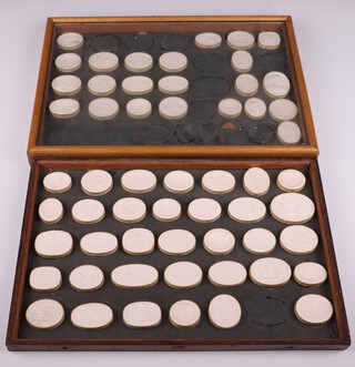 A collection of Grand Tour plaster intaglios decorated with classical figures at pursuits, 57 framed as 2