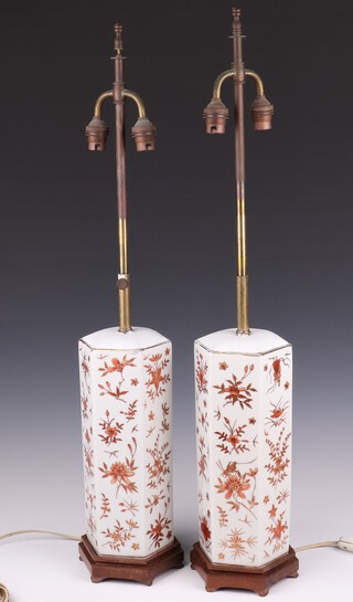 A pair of modern Chinese hexagonal ochre  table lamps decorated with flowers on hardwood stands, 34cm 