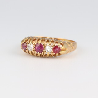 An 18ct yellow gold diamond and ruby ring, the 3 rubies 0.20ct, the 2 brilliant cut diamonds 0.10ct, size P, 3.4 grams 