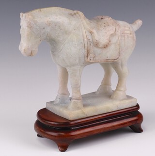A 20th Century carved soapstone figure of a standing horse on a rectangular base 14cm with hardwood stand and fitted box