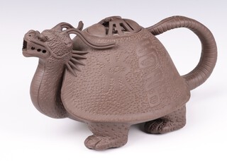 A 20th Century tan ware Chinese teapot with dragon spout and shell body with characters, 26cm, boxed