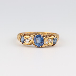 An 18ct yellow gold sapphire and diamond ring, the sapphires 0.7ct, the diamonds 0.03ct, size O 1/2, 3 grams