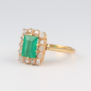 An 18ct yellow gold baguette cut emerald and diamond ring, the centre stone 1.5ct, the brilliant cut diamonds 0.4ct, size K, 4.7 grams