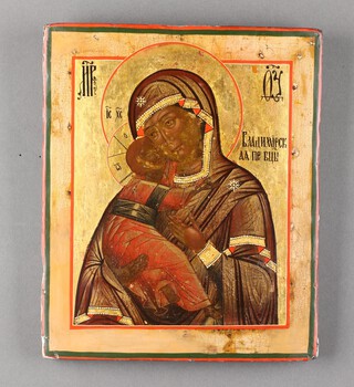 An early 20th Century Icon on panel, The Virgin and Child, with Russian characters 31cm x 26cm 