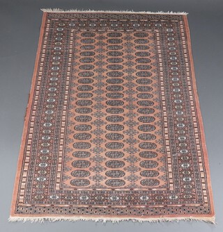A pink and black ground Bokhara rug with 60 octagons to the centre within a multi row border 197cm x 127cm 