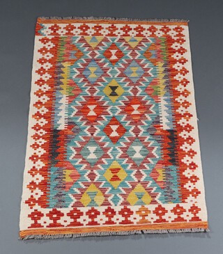 A white, turquoise and green ground Chobi Kilim with all over diamond design 122cm x 80cm 