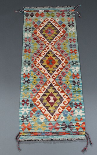 A turquoise, black and green ground Chobi Kilim runner with 3 diamonds to the centre 149cm x 53cm 