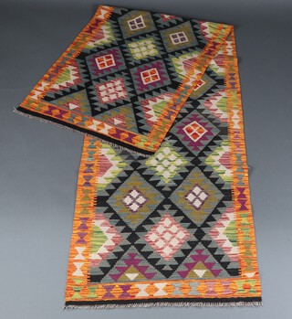 A black, grey and purple ground Maimana Kilim runner with oval diamond design 315cm x 89cm 