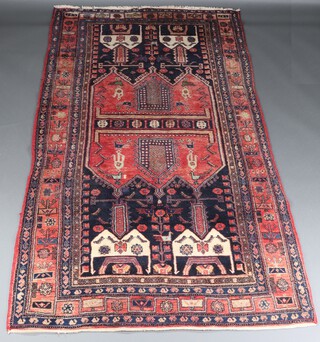 A red, blue and white ground Afghan rug with bird decoration within a multi row border 273cm x 153cm 