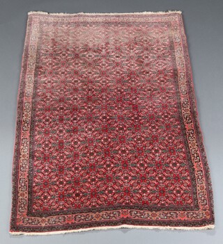 A North Persian red and floral pattern rug with overall geometric design 158cm x 109cm 