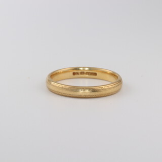 An 18ct yellow gold wedding band size O, 3.3 grams 