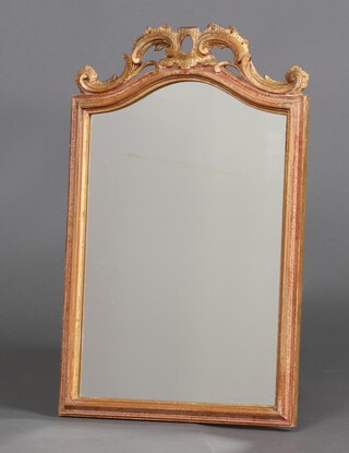 A Rococo style arched plate mirror contained in a carved wooden frame 57cm h x 35cm d 