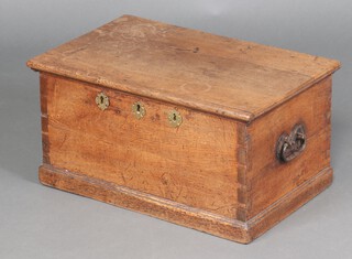 An 18th Century oak strong box with iron drop handles to the sides, the interior fitted a candle box, having long iron hinges and 3 locks (1 lock missing) 31cm h x 61cm w x 40cm d 