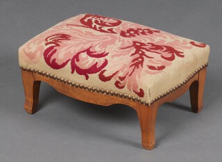 A 19th Century Continental rectangular walnut footstool with Berlin woolwork seat, raised on cabriole supports 15cm h x 34cm w x 26cm d 