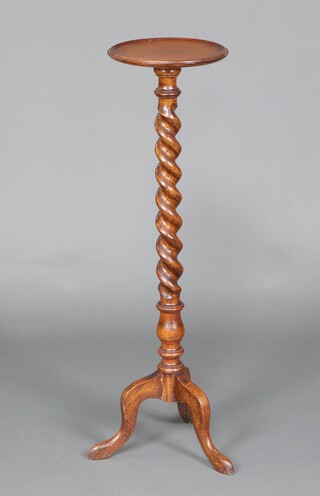 A 1930's circular oak jardiniere stand raised on spiral turned column supports with tripod base 107cm h x 27cm diam. 