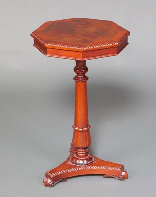 A William IV style octagonal crossbanded mahogany occasional table, raised on a turned column and triform base with scroll feet 70cm h x 41cm w x 41cm d 