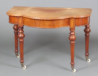 A Victorian bleached mahogany dressing table of shaped outline, fitted a frieze drawer, raised on turned and fluted supports ending in ceramic casters 74cm h x 108cm w x 63cmm d 